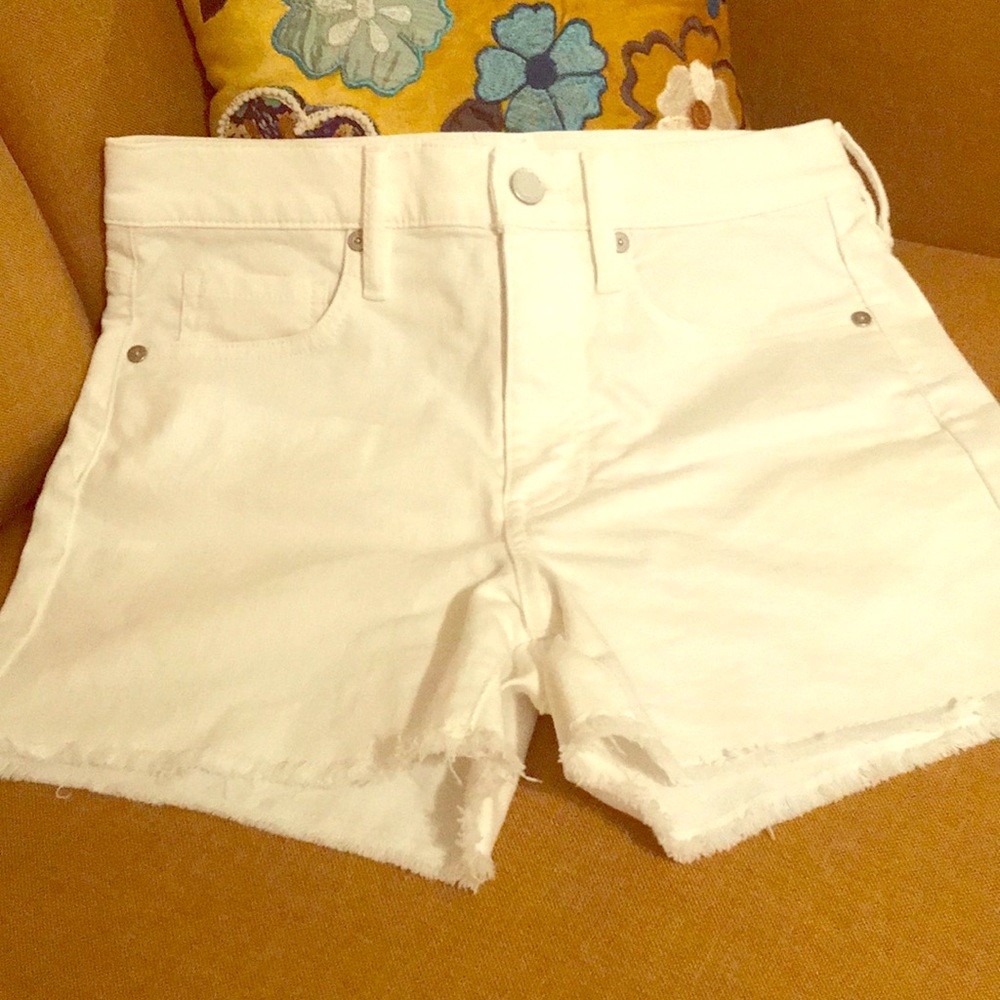 White denim high rise shorts.
